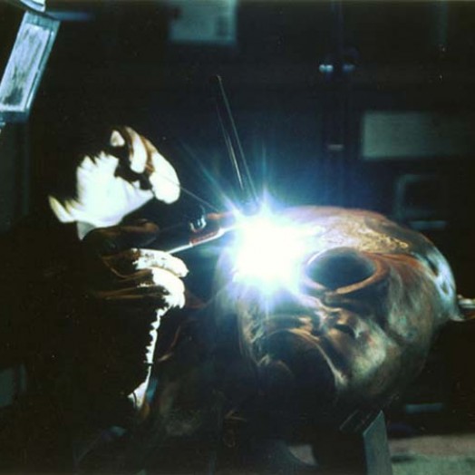 A stainless steel rod is welded into the structure of the fish during the early stages of the work