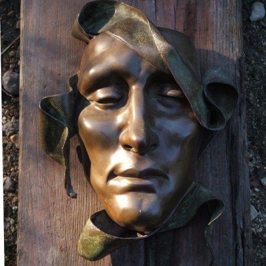 A serene but haunting mask with a flowing sash ...